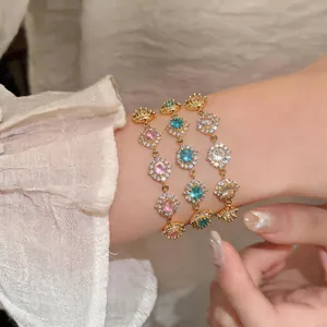 Primo piano di eleganti bracciali in oro 18 carati e zirconi con pietre tonde sul polso