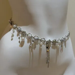 Detailed view of silver star waist chain with faux pearls and rhinestones on mannequin