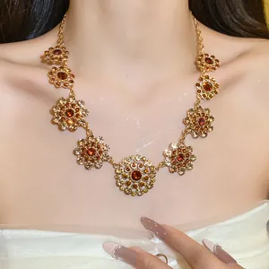 Detailed close-up of vintage court style necklace with red rhinestones on model's neck.