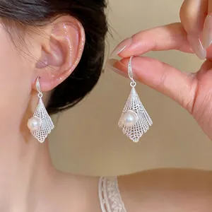 Exquisite French style hollow lace drop earrings featuring a central pearl and silver finish