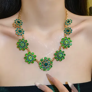 Detailed macro view of vintage court style necklace with green crystal flower motifs