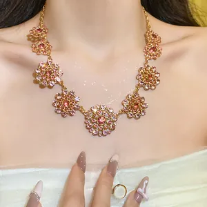 Detailed macro view of a vintage royal style necklace with pink crystals on the model