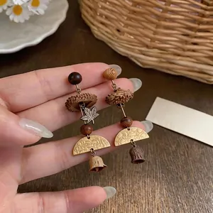 Vintage handcrafted forest style earrings featuring plant nuts and metal maple leaf
