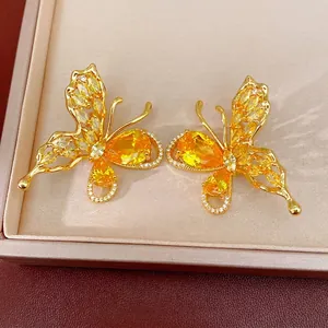 Elegant 18K gold plated butterfly stud earrings with sparkling yellow zircon crystals