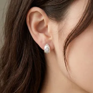 Minimalist frosted silver teardrop earrings featuring a sparkling zircon star pattern