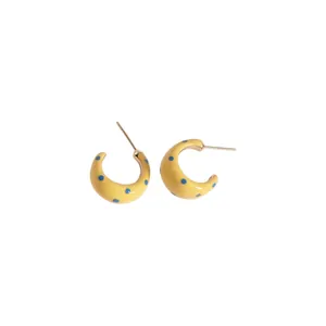 Elegant yellow enamel C-shaped hoop earrings featuring playful blue polka dot patterns