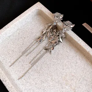 Close-up of vintage silver wheat spike tassel clip-on earrings with sparkling zircon details