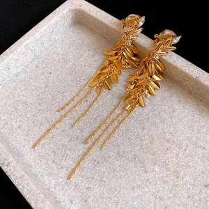 Detailed close-up of vintage gold wheat ear tassel clip-on earrings with zircon accents