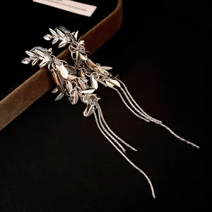 Macro detail view of vintage silver wheat leaf tassel earrings with zircon accents.