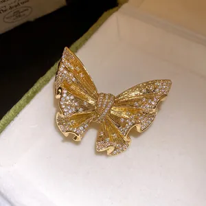 Detail view of luxury 18k gold plated butterfly brooch with sparkling crystals in a box