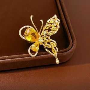 Detailed view of a gold-plated butterfly earring with sparkling yellow zircon stones.