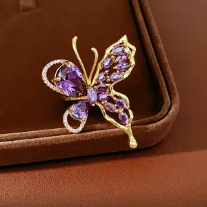 Close-up detail showing exquisite purple zircon stones on a gold-plated butterfly earring