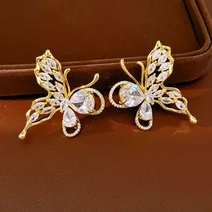 Detailed view of gold-plated butterfly stud earrings with sparkling cubic zirconia