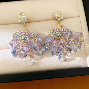 Elegant fan-shaped tassel earrings featuring violet zircon and glass crystals on gold studs
