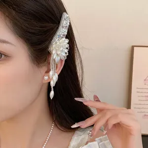 Elegant pearl flower hair clip with tassel and rhinestones shown on model