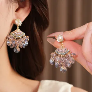 Macro view of court style fan tassel earrings with zircon and lilac glass crystals