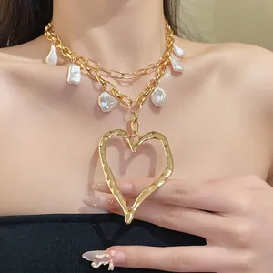 Vintage gold layered necklace with baroque pearls and a large hammered hollow heart pendant