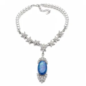 Elegant pearl beaded necklace featuring crystal flower links and a starry blue oval pendant.