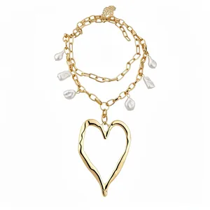 Elegant gold chunky chain necklace with baroque pearls and a large irregular heart pendant