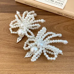 Detailed macro shot of elegant white pearl beaded flower hair clips on wooden background