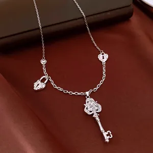 Exquisite silver key necklace with sparkling zircon stones and heart-shaped lock charms.