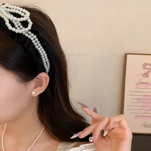 Close-up side view of a stylish woman wearing an elegant pearl flower hair accessory