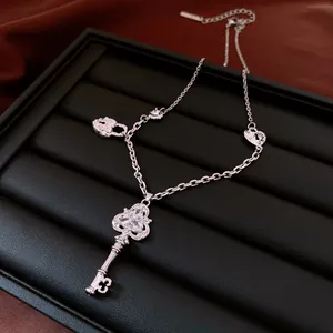 Exquisite silver key necklace featuring heart and lock charms with shimmering zircon accents