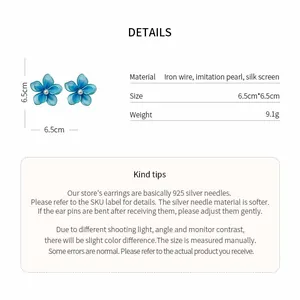 Detailed view of blue silk screen flower earrings with pearl and size information