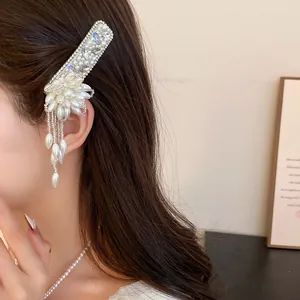 Elegant pearl flower tassel hair clip with rhinestones worn by a model