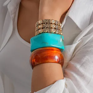 Detailed view of bohemian elastic rhinestone bracelet and colorful acrylic bangles