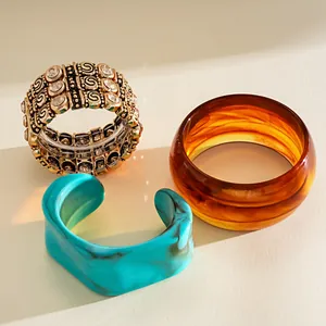 Detail shot of vintage rhinestone elastic bracelet and marbled acrylic bangles set