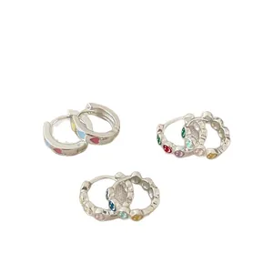 Minimalist silver hoop earrings with colorful enamel hearts and smiley face details