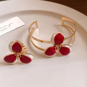 Elegant vintage gold metal cuff bracelet and ring set with red drip oil flower design