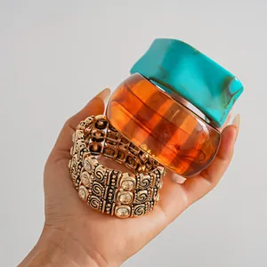 Close-up of retro rhinestone stretch bracelet and chunky acrylic geometric bangles