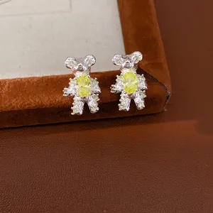 Silver bear stud earrings with yellow zircon crystals in a cute fashion style