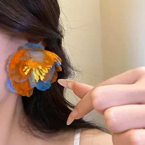 Vibrant large bohemian chiffon flower stud earrings featuring orange and blue petals