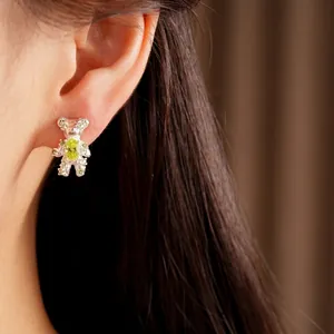 Elegant bear stud earrings featuring green zircons on a silver needle for women's jewelry