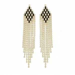 Elegant gold tassel earrings with diamond-shaped rhinestone pattern on white background