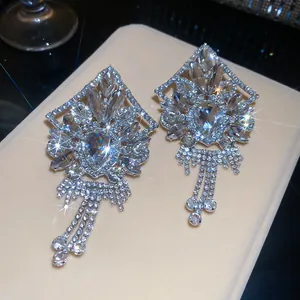 Close-up of sparkling rhinestone rhombus tassel earrings with elegant silver needles