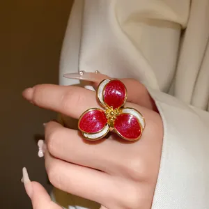Macro view showing the detailed dripping oil texture on the red flower ring