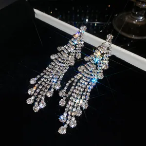 Close-up macro view of sparkling diamond long tassel earrings with vintage luxury design