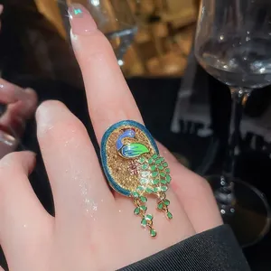 Elegant vintage style 18K gold plated peacock adjustable ring with dangling tail detail