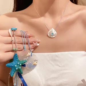 Ocean-themed starfish pearl necklace perfect for beach vacations, worn by a female model.