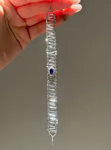Detailed view of an elegant silver-toned hollow bracelet featuring an oval blue zircon center