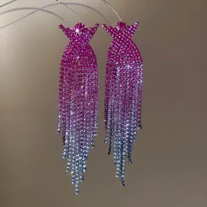 Detailed view of pink to silver gradient rhinestone tassel earrings with sparkle