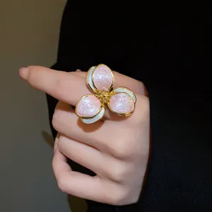 Detailed macro view of a vintage flower open ring with shimmering pink enamel petals