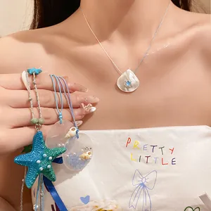Beach style necklace with shell pendant and colorful starfish accessory.