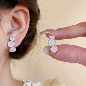 Sweet C-shaped earrings with pink enamel flowers and zircon accents on silver pins