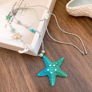 Macro shot showing the detailed texture of the green starfish pendant and jewelry charms