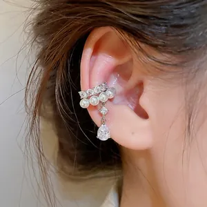 Elegant gold-tone pearl and teardrop zircon ear cuff for non-pierced ears on model